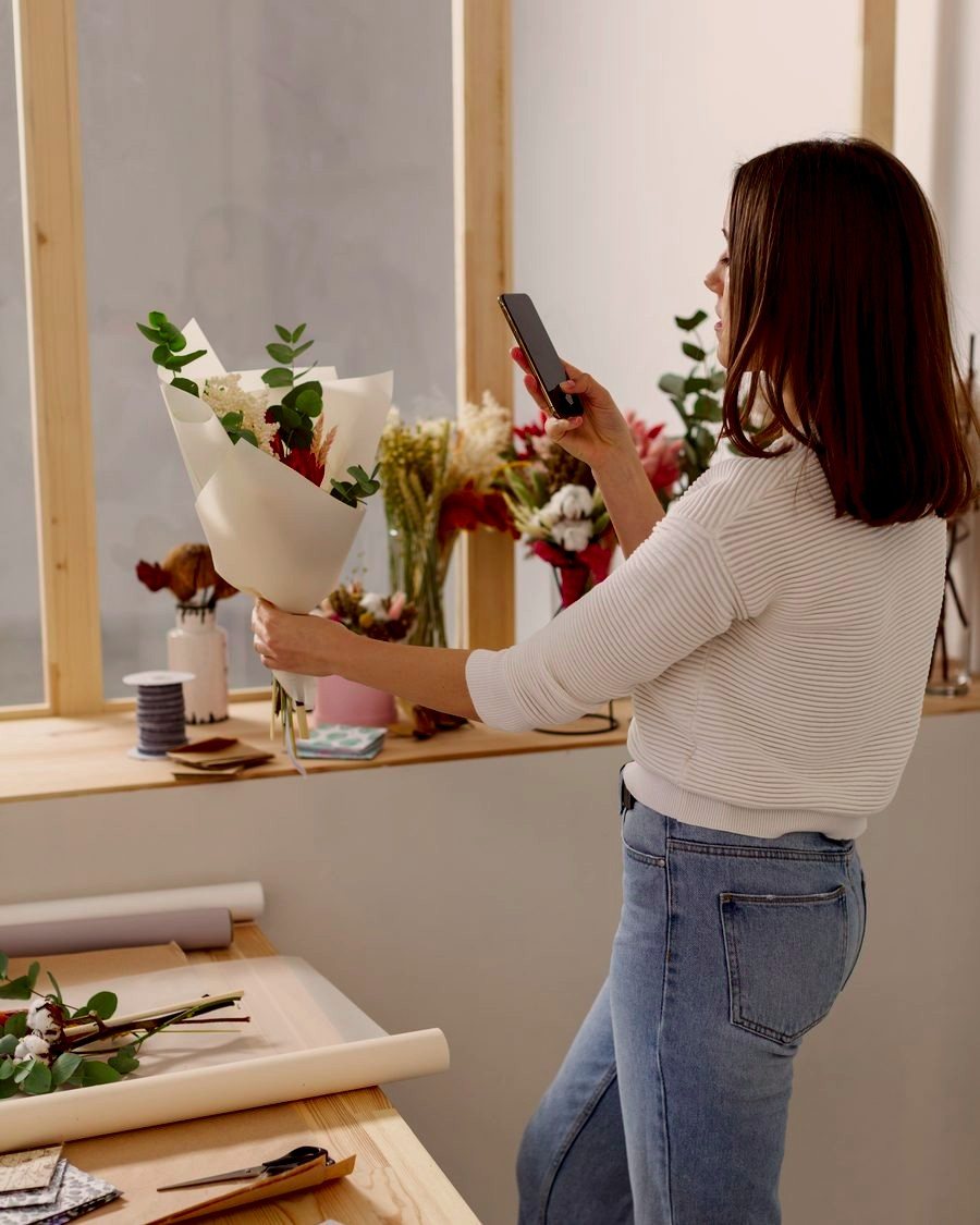 Florista fotografiando un ramo en su tienda